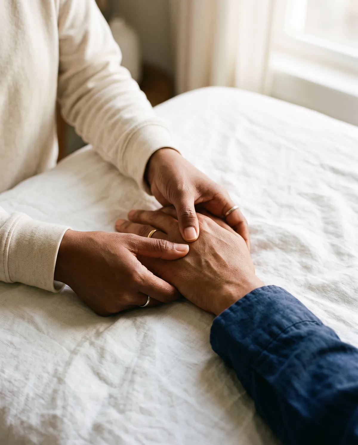 Healer pressing an acupressure point on the back of a patient's hand